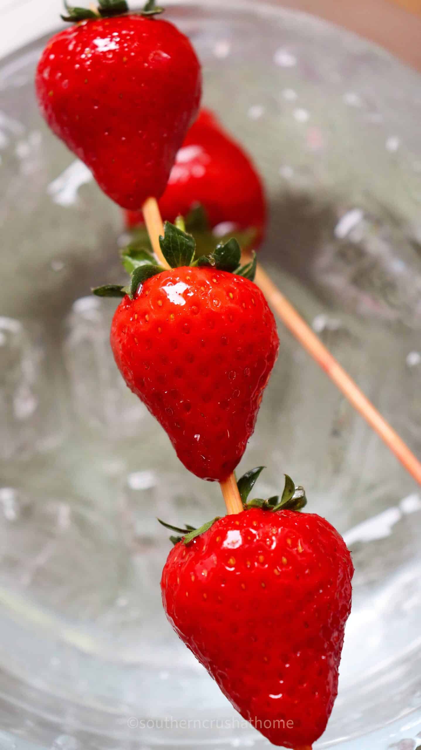 up close view of coated strawberries after dipped in ice water bath