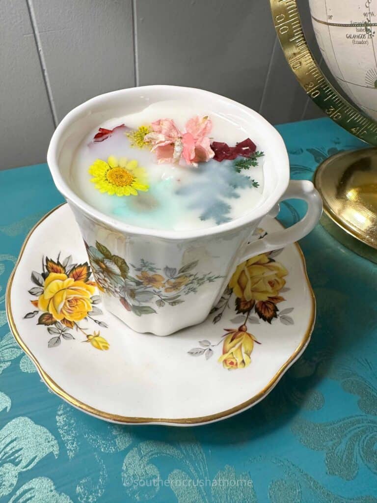 tea cup candle with dried flowers on display