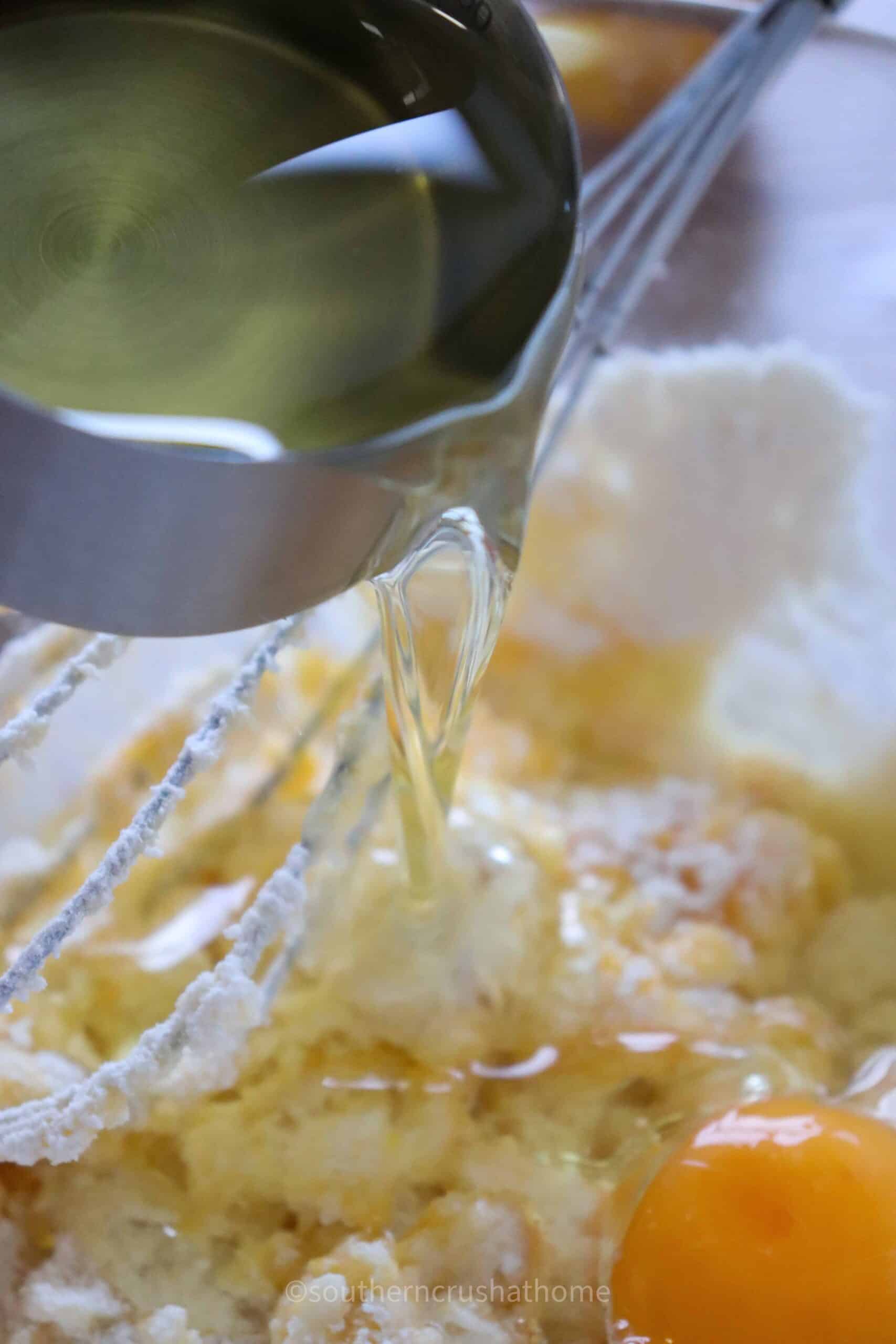 adding oil to lemon loaf batter
