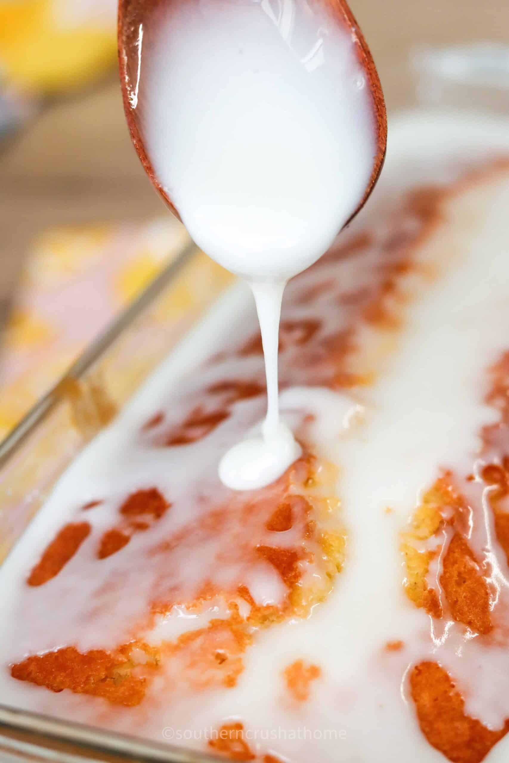 close up of drizzling glaze icing on lemon loaf