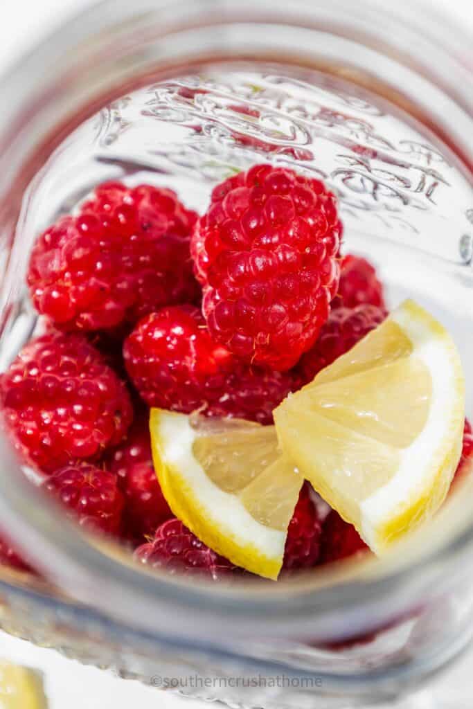 raspberry lemon mint mocktail ingedients in a pitcher