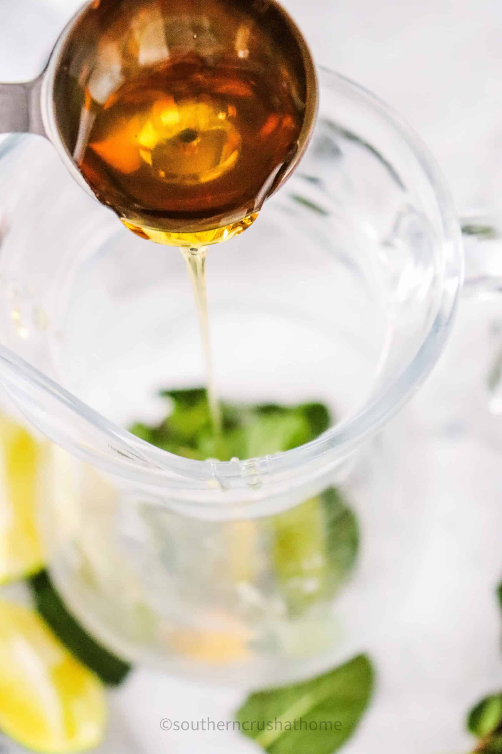 pouring agave into mocktail