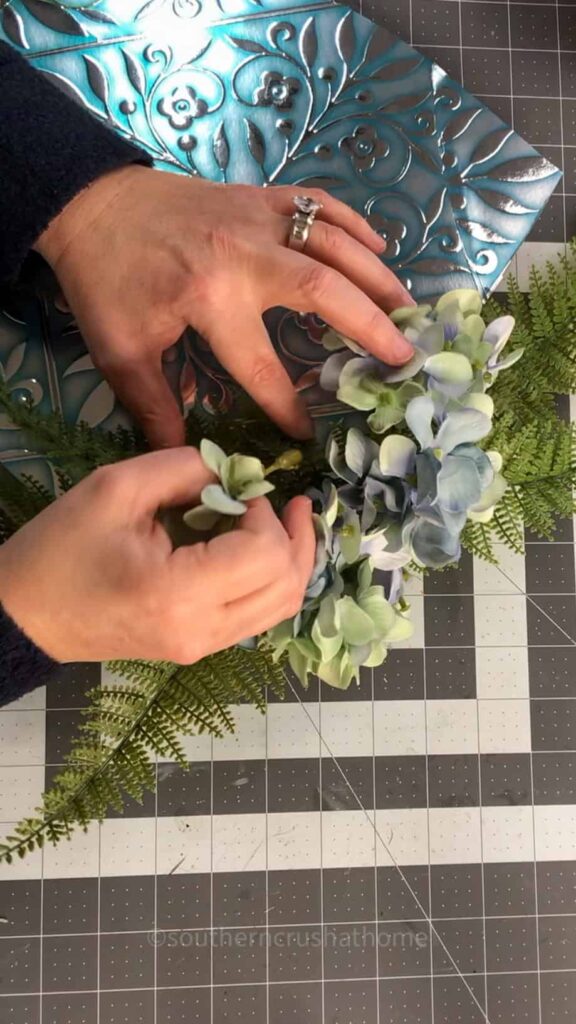 adding florals to wreath