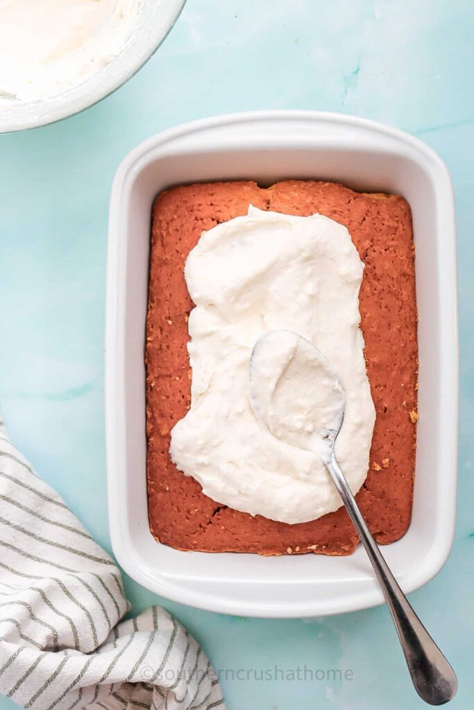 spreading frosting on cake