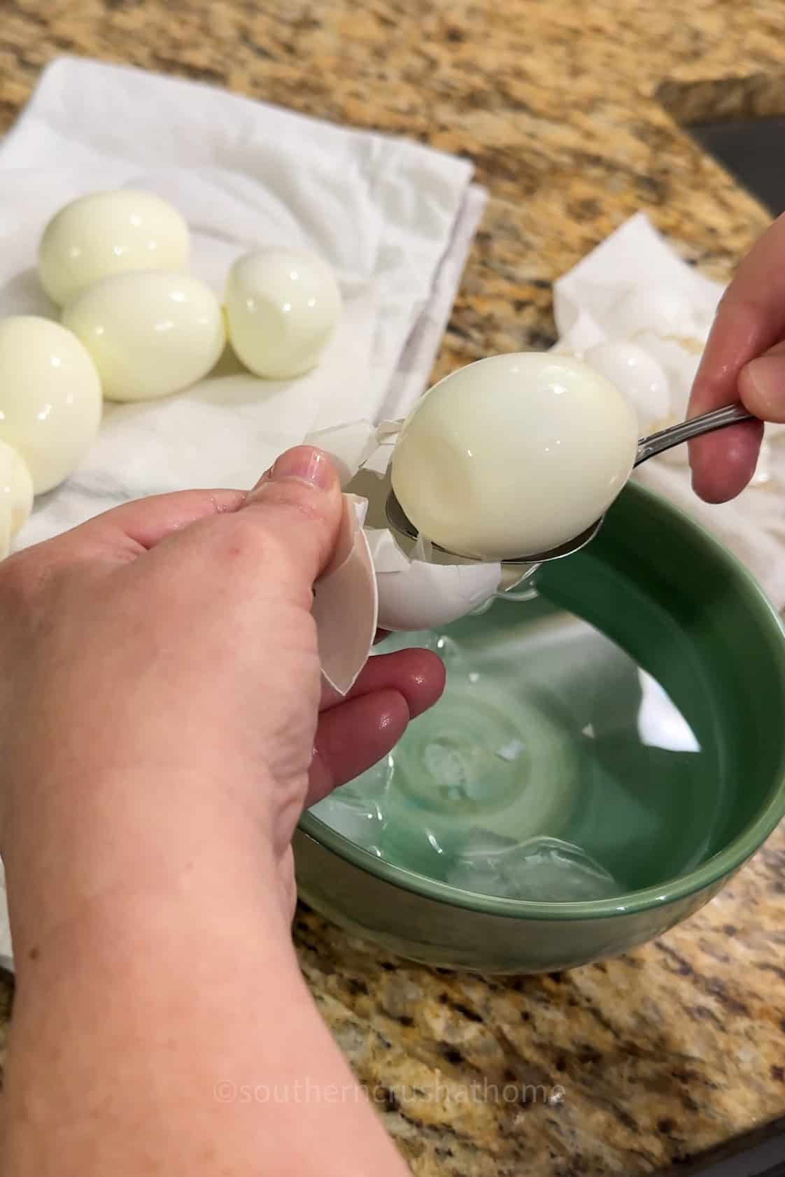 removing a hard boiled egg with a spoon