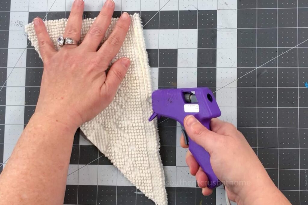 adding bead of fabric glue to chenille