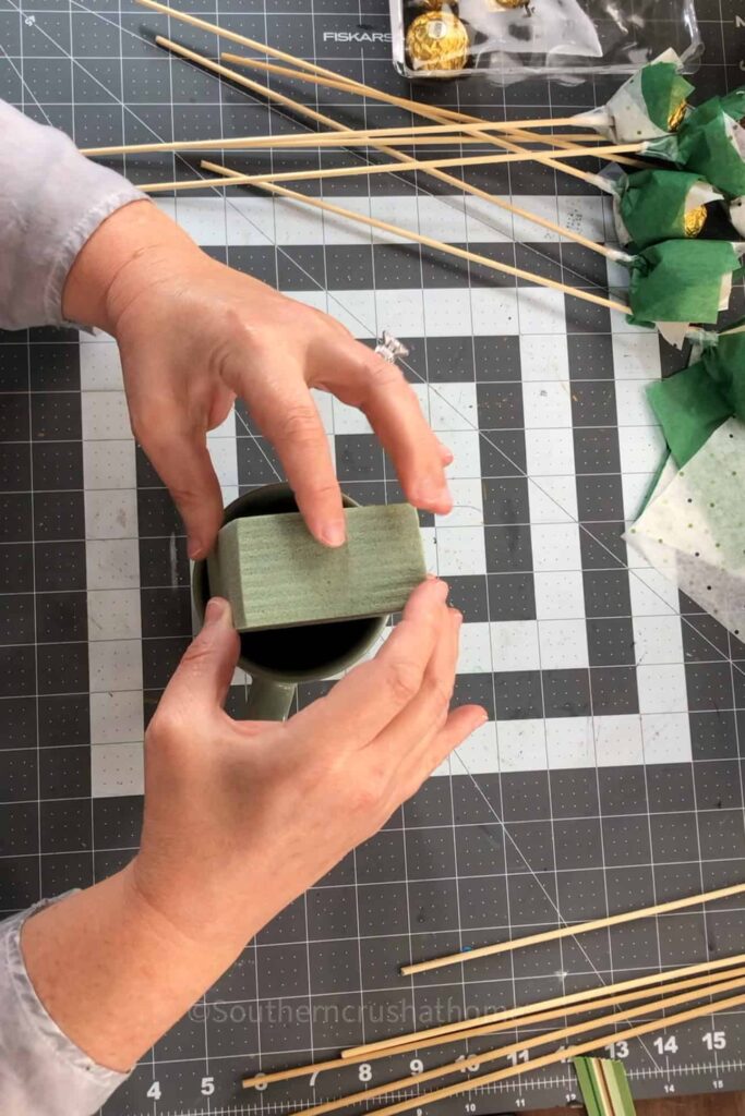 adding floral foam to mug