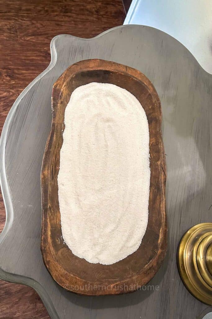 adding sand to dough bowl