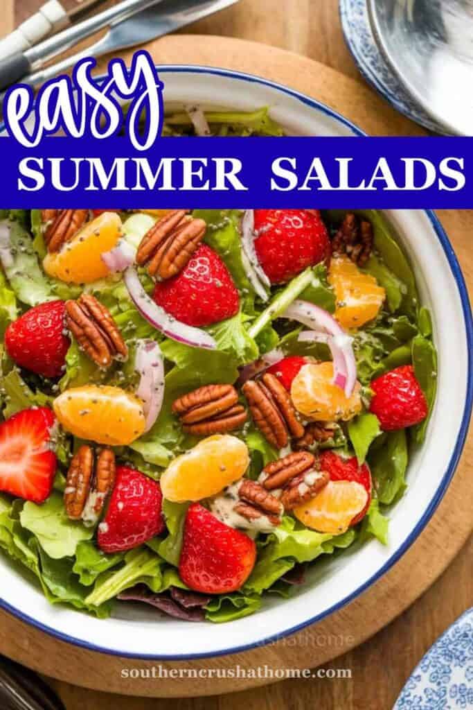 A vibrant Summer Strawberry Salad with greens, strawberries, pecans, and dressing.