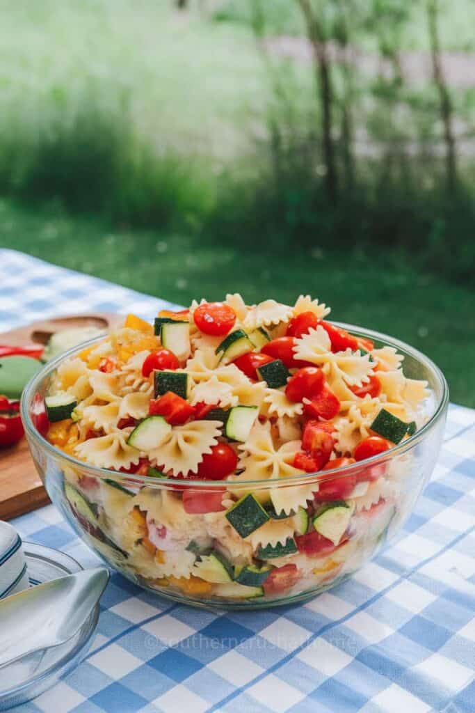 A colorful bowl of Summer Vegetable Pasta Salad with various fresh vegetables.