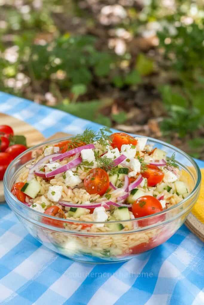 Delicious orzo salad with fresh vegetables and herbs.