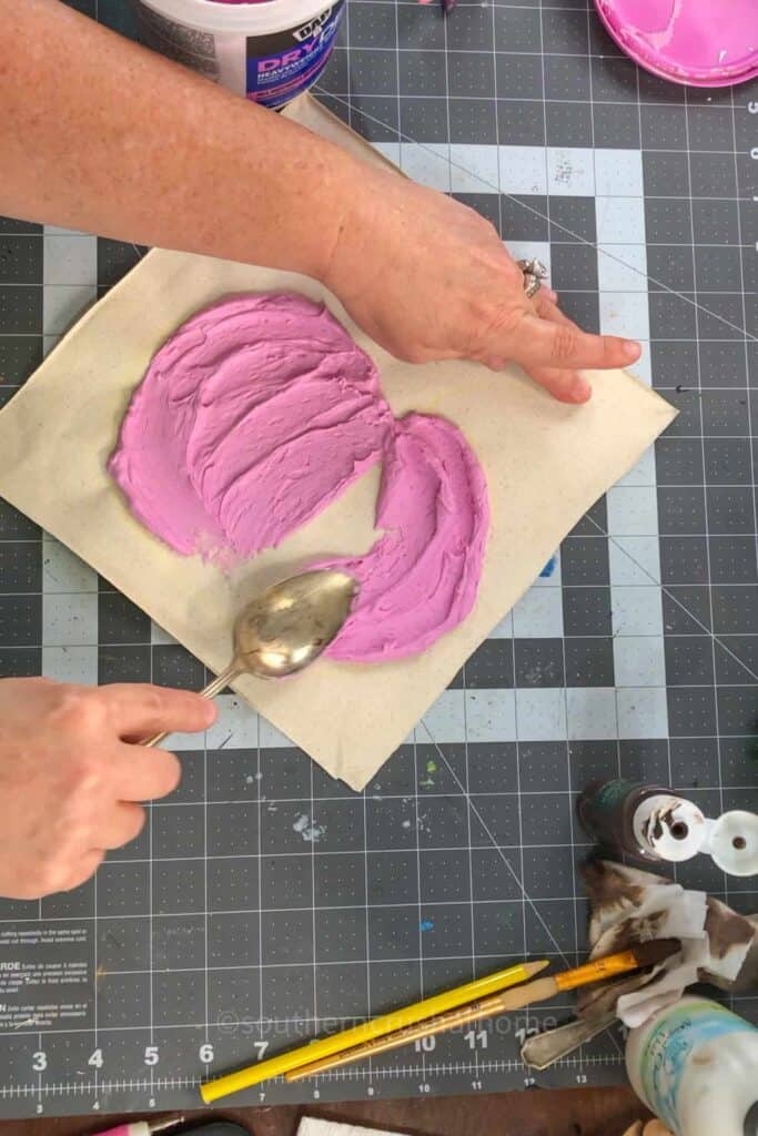 applying spackle to canvas