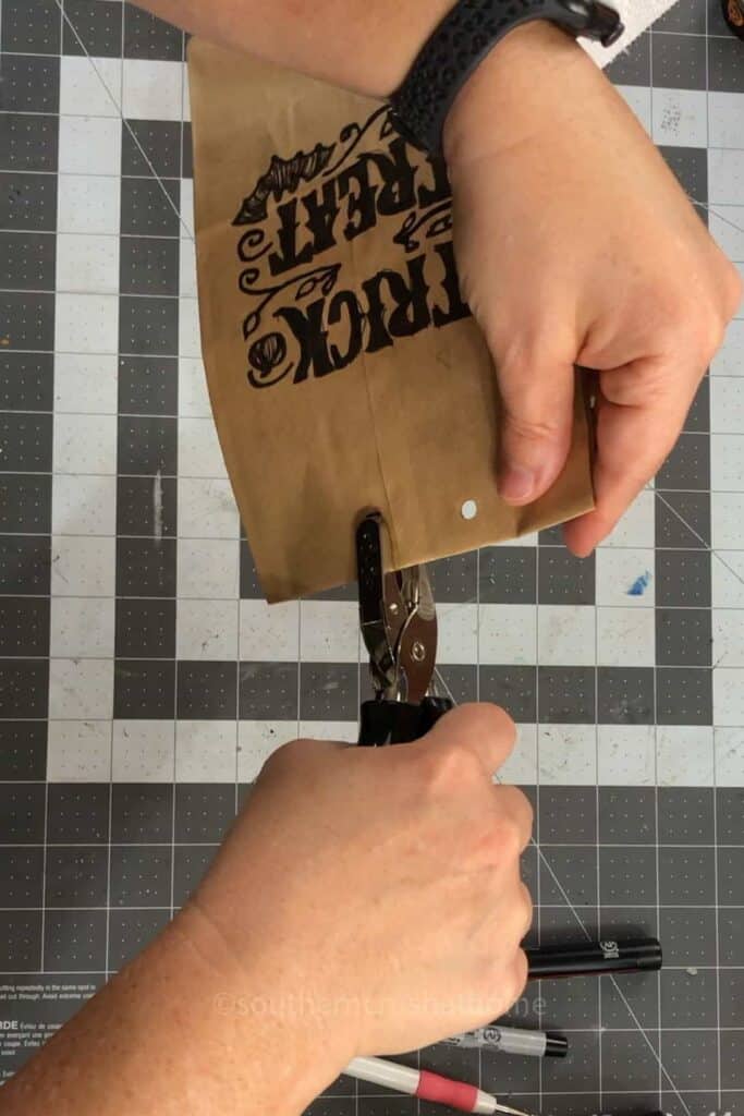 hole punching brown paper bag