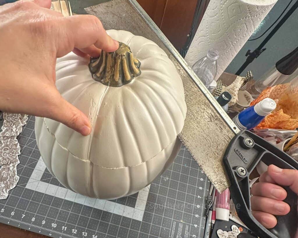 cutting top off of faux pumpkin
