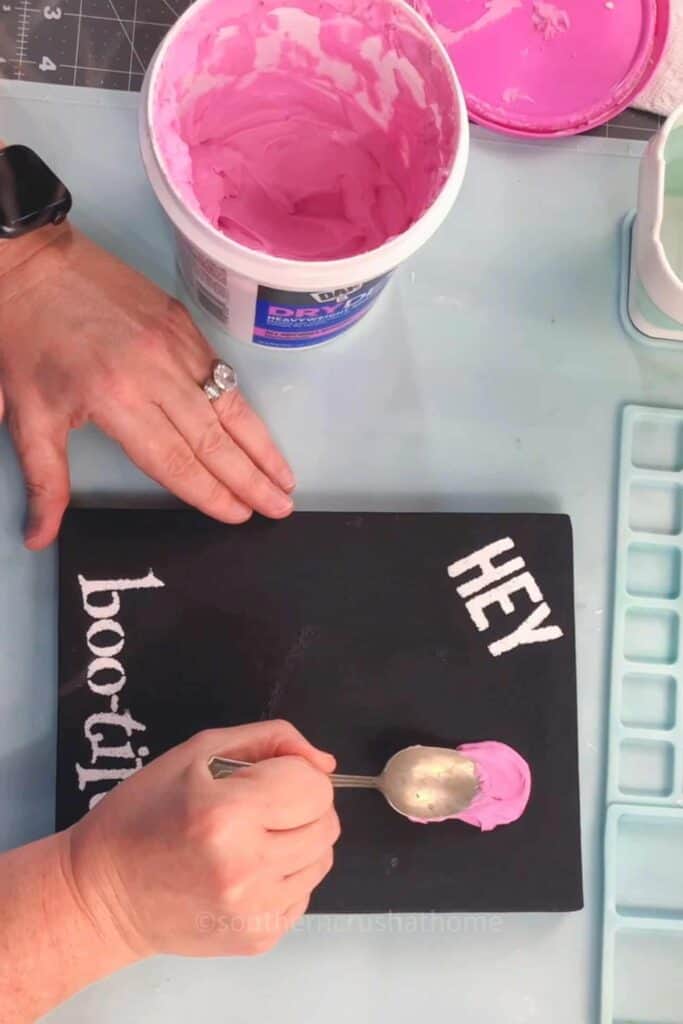 applying spackle to canvas