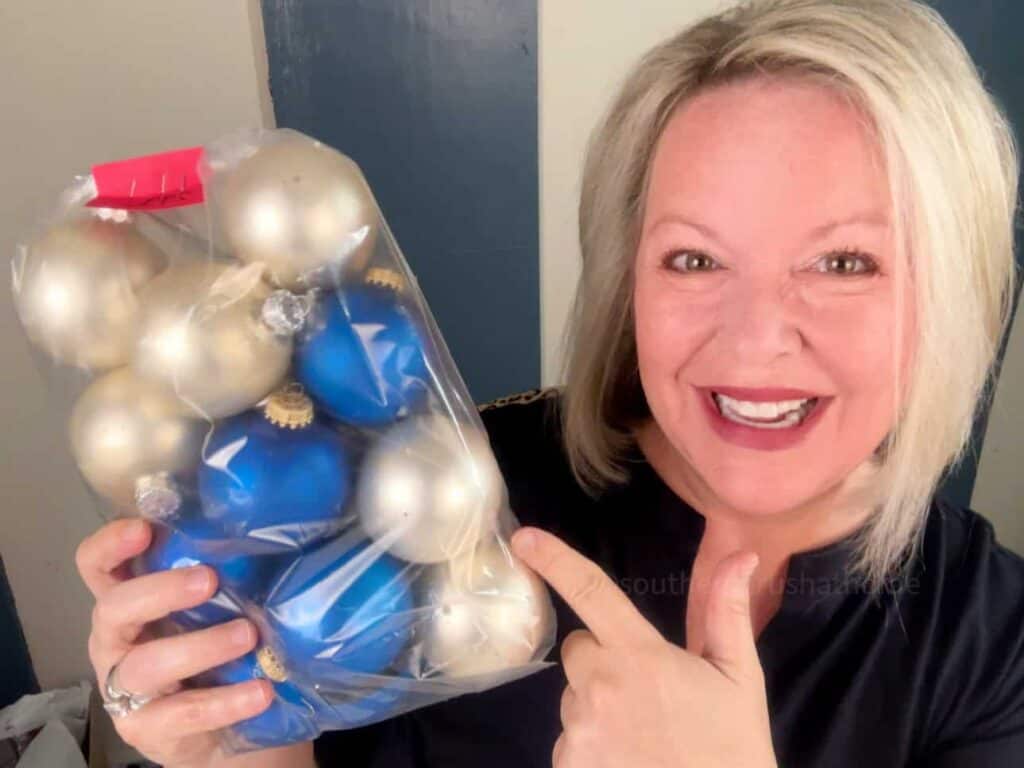 Melanie Ferguson holding a bag of thrifted vintage ornaments