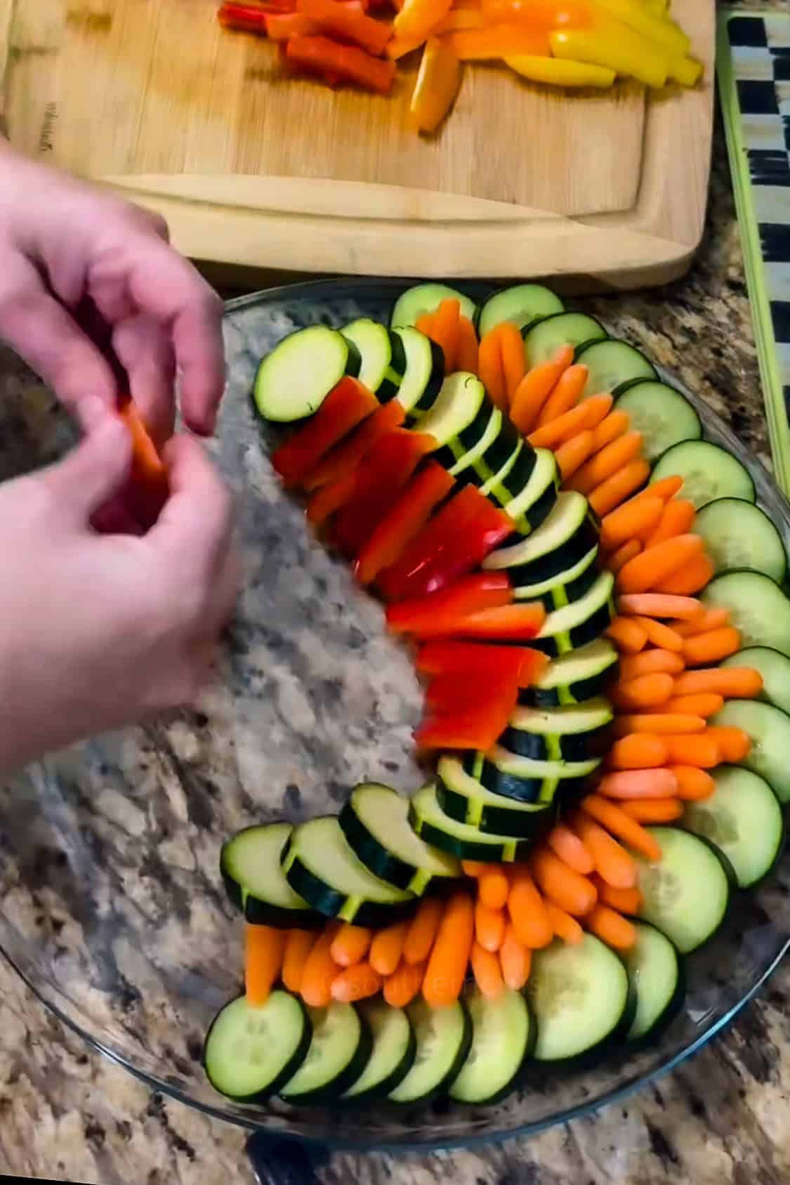 adding veggies to crudite platter