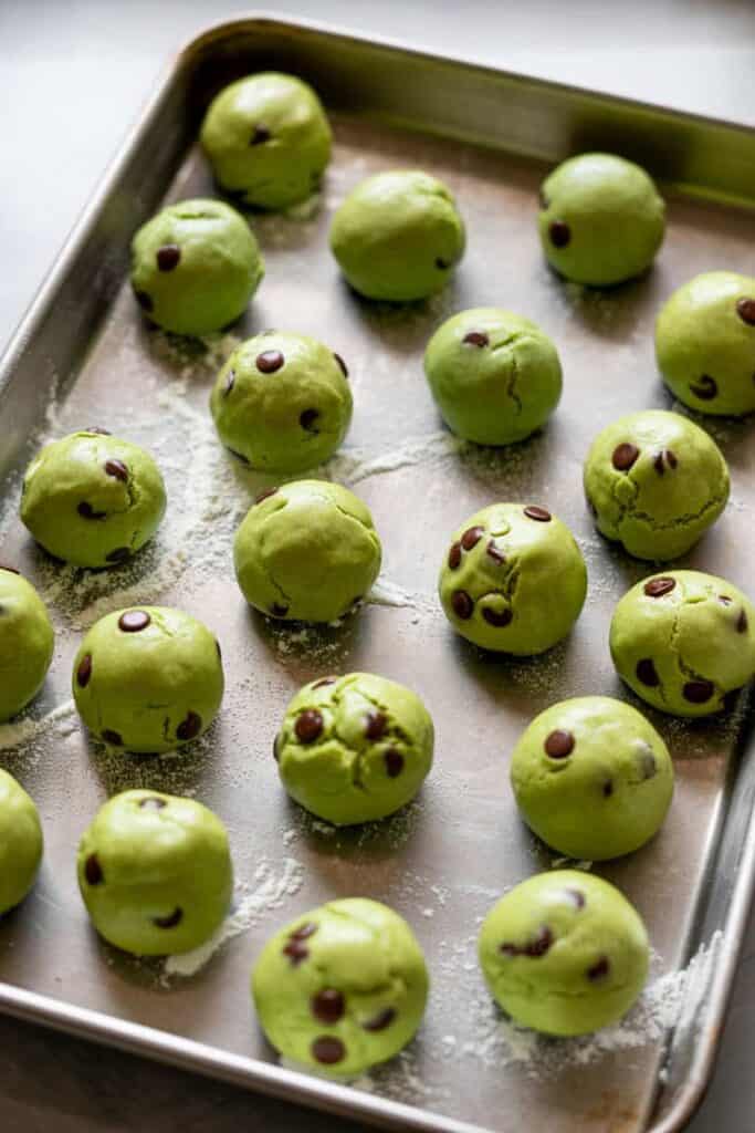 grinch cookies on baking sheet